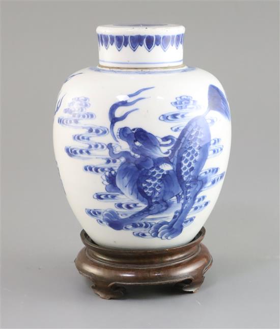 A Chinese blue and white qilin jar and cover, Kangxi period, H. 16cm, wood stand